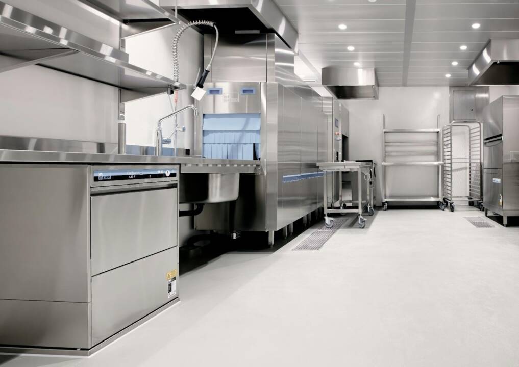 A modern, clean commercial kitchen featuring stainless steel appliances and professional ventilation after a successful project by a restaurant contractor in Toronto.